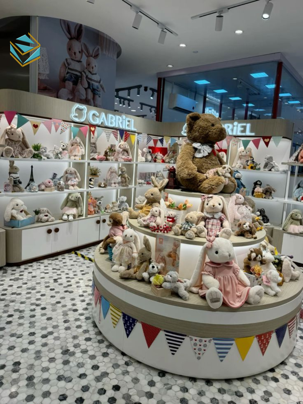 Showroom được thi công cửa hàng quà tặng lưu niệm theo concept hiện đại, sử dụng ánh sáng LED trắng, quầy trung tâm và gương phản sáng giúp tăng chiều sâu không gian.